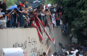 Protesters destroy an American flag pulled down from the U.S. embassy in Cairo, Egypt, on Sept. 11, 2012. (AP Images)