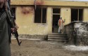 Afghan police officer stands guard at the site of an explosion in the Imam Sahib district of Kunduz / AP