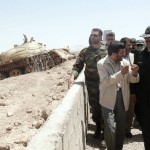 Iranian President Mahmoud Ahmadinejad talks with IRGC commander / AP