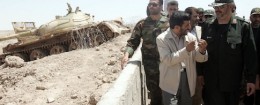 Iranian President Mahmoud Ahmadinejad talks with IRGC commander / AP