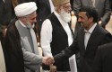 Iranian President Mahmoud Ahmadinejad shakes hands with deputy leader of Lebanese Hezbollah / AP