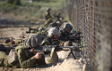 Israeli troops along the border fence between Israel and Syria / AP