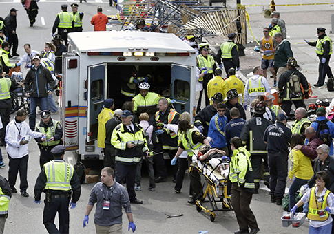 Medical workers aid injured people at the finish line of the 2013 Boston Marathon / AP