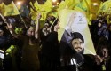 Hezbollah supporters wave the party's flags in 2011 / AP