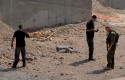 Israeli security investigates the scene of a rocket attack in Eilat, Israel, Wednesday, April 17, 2013. (AP)