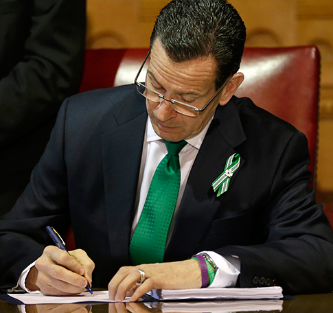 Gov. Dannel Malloy signs into law Connecticut's strict new gun laws. (AP)