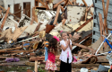 Two girls stand in rubble after a tornado struck Moore, Okla. REUTERS/Gene Blevins