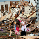 Two girls stand in rubble after a tornado struck Moore, Okla. REUTERS/Gene Blevins