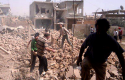 Syrians inspect rubble of damaged buildings due to government airstrikes, in Qusair, Syria. The town has been besieged by regime troops and pro-government gunmen backed by Hezbollah. (AP)