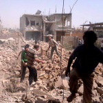 Syrians inspect rubble of damaged buildings due to government airstrikes, in Qusair, Syria. The town has been besieged by regime troops and pro-government gunmen backed by Hezbollah. (AP)