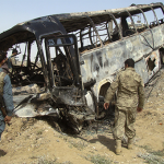 Burned bus after it collided with the wreckage of a truck that was attacked by Taliban insurgents in Afghanistan / AP