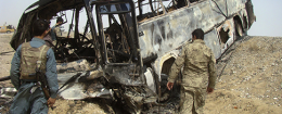 Burned bus after it collided with the wreckage of a truck that was attacked by Taliban insurgents in Afghanistan / AP