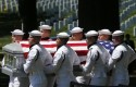 Navy honor guard members carry the casket for Vietnam War sailors missing from the Vietnam War on May 2, 2013 / AP