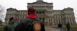 International Brotherhood of Electrical Workers members stand outside the capitol in Lansing, Friday, Dec. 7, 2012