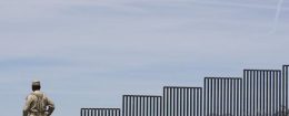 A Mexican soldier patrols along the U.S.-Mexico border wall on the outskirts of Nogales, Mexico
