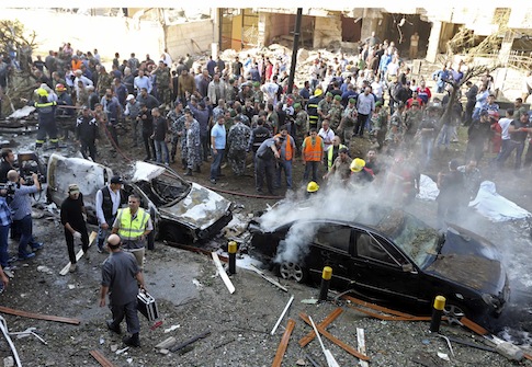 Soldiers, policemen and medical personnel gather at the site of explosions near the Iranian embassy in Beirut