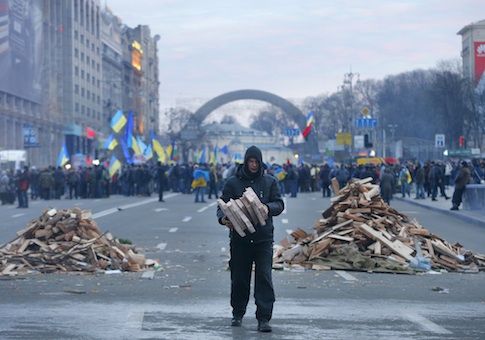 A protester collects firewood for heating in downtown Kiev