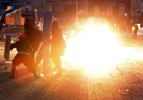 A stun grenade explodes as protesters clash with police
