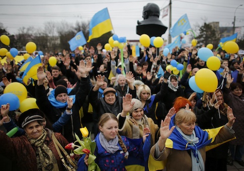 Pro-Ukrainian supporters raise their hands as they take part in a rally in Simferopol