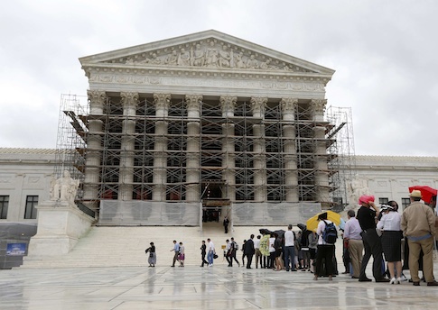 Visitors to the Supreme Court are pictured in the rain in Washington