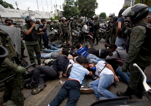 Bolivarian National Guardsmen surround a group of anti-government demonstrators