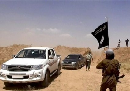 Militants from the al-Qaida-inspired Islamic State of Iraq and the Levant (ISIL) removing part of the soil barrier on the Iraq-Syria borders and moving through it