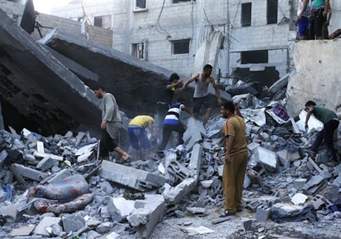 Palestinians remove rubble from the destroyed Ghanam family home in Rafah