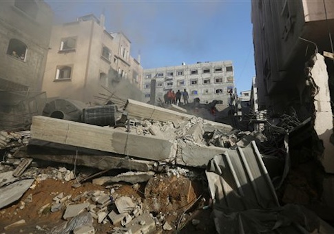 Palestinians inspect the rubble of a house after it was hit by an Israeli missile strike in Gaza City, Thursday, July 10