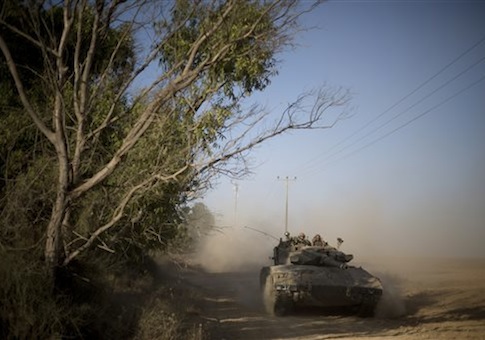 Israeli soldiers drive a tank to a position near the Israel Gaza border, Thursday, July 10