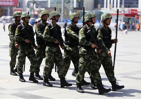 Armed paramilitary policemen patrol the square in front of the Zhengzhou Railway Station in Zhengzhou city, central Chinas Henan province