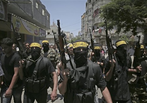 Masked militants march with guns