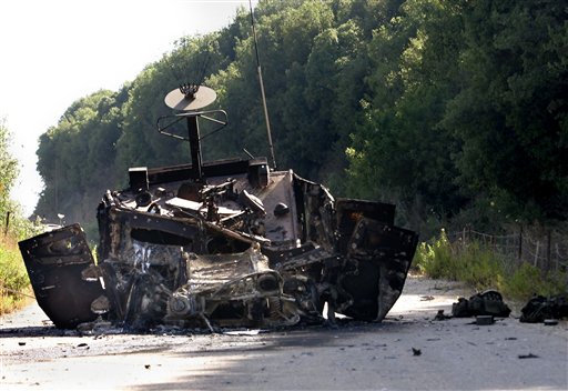 A burned Israeli humvee that was part of a convoy attacked by Hezbollah guerillas where two Israeli soldiers were captured, is seen on a road between Zarit and Shtula in northern Israel, on the border with Lebanon, Wednesday, July 12, 2006