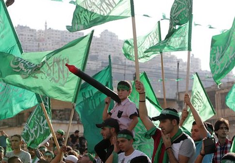 Palestinians hold Hamas flags and chant slogans during a celebration organized by Hamas in the West Bank city of Nablus