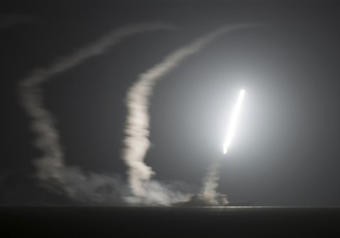 In this photo released by the U.S. Navy, the guided-missile cruiser USS Philippine Sea launches a Tomahawk cruise missile at Islamic State group positions in Syria
