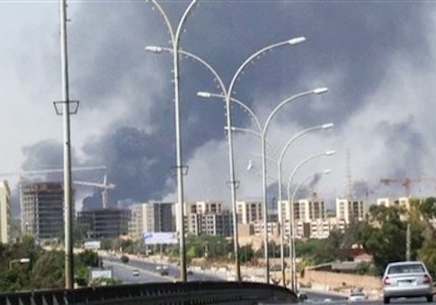In this image made from video by The Associated Press, smoke rises from the direction of Tripoli airport in Tripoli, Libya, Sunday, July 13, 2014. Rival militias battled Sunday for the control of the international airport in Libya's capital