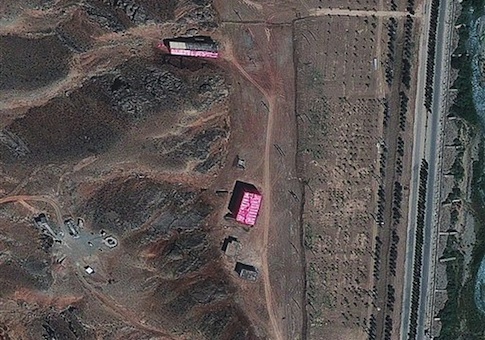 In this satellite image supplied Friday Aug. 24, 2012, by the Institute for Science and International Security (ISIS), showing what they say are buildings, seen here at centre and top, shrouded with a pink tarp to stop the U.N nuclear agency from monitoring Tehran's efforts to sanitize the site which they suspect was used for secret work on atomic weapons, in this photo dated Aug. 15, 2012, of the Parchin military complex southeast of Tehran, Iran