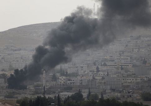 Smoke rises in the Syrian town of Kobani, as seen from the southeastern town of Suruc near the Mursitpinar border crossing on the Turkish-Syrian border October 10