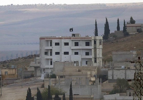 An Islamic State flag is seen in east Kobani