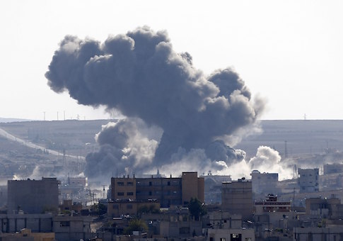 An explosion following an air strike is seen in central Kobani November, 10 2014