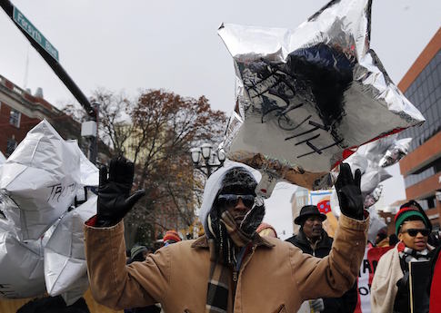 Demonstrators march through the streets during a protest over the shooting death of Michael Brown in Clayton, Missouri