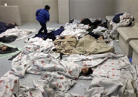 detainees sleep in a holding cell at a U.S. Customs and Border Protection processing facility in Brownsville,Texas