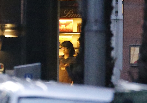 A woman is seen in a window of the Lindt cafe, where hostages are being held, at Martin Place in central Sydney