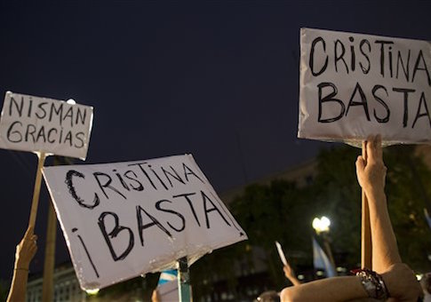 Protesters hold signs that read in Spanish "Enough Cristina!" and "Thank you Nisman" outside the government palace in Plaza de Mayo after the death of special prosecutor Alberto Nisman in Buenos Aires, Argentina