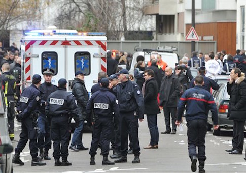 Police officers inspect the crime scene where at least 12 people were killed in a shooting at the offices of satirical weekly Charlie Hebdo in Paris, France, on Jan. 7, 2015