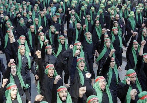 Lebanese Hezbollah supporters shout slogans as they march during Ashoura day in Beirut's southern suburbs, Lebanon, Tuesday, Dec. 6, 2011