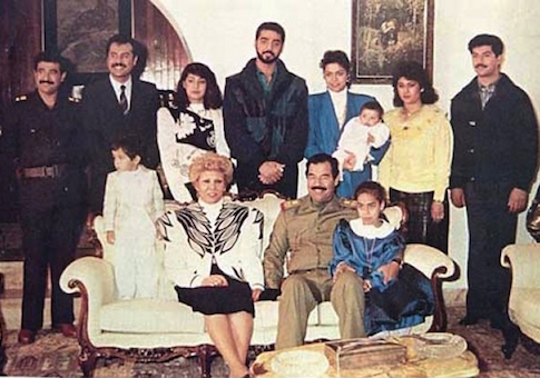 Raghad, in the blue blazer, holds her baby in this photograph of the Saddam Hussein family from 1980s