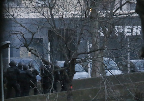 Smoke is seen at left as French police launch their assault at a kosher supermarket in eastern Paris, January 9