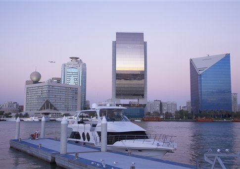 Yacht docked in urban bay, Dubai, United Arab Emirates