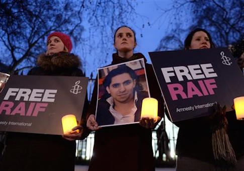 Raif Badawi protest. Protesters during an Amnesty International candle-lit protest vigil for blogger and free speech activist Raif Badawi outside the Saudi Arabia Embassy. In Mayfair, London