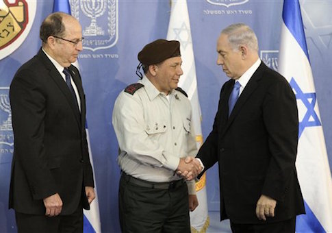 Israeli Prime Minister Benjamin Netanyahu, right, shakes hands with the new Israeli Chief of Staff Major Gen. Gadi Eisenkot, during a ceremony in Jerusalem Monday, Feb. 16, 2015. On the left is Israeli Defense Minister Moshe Yaalon